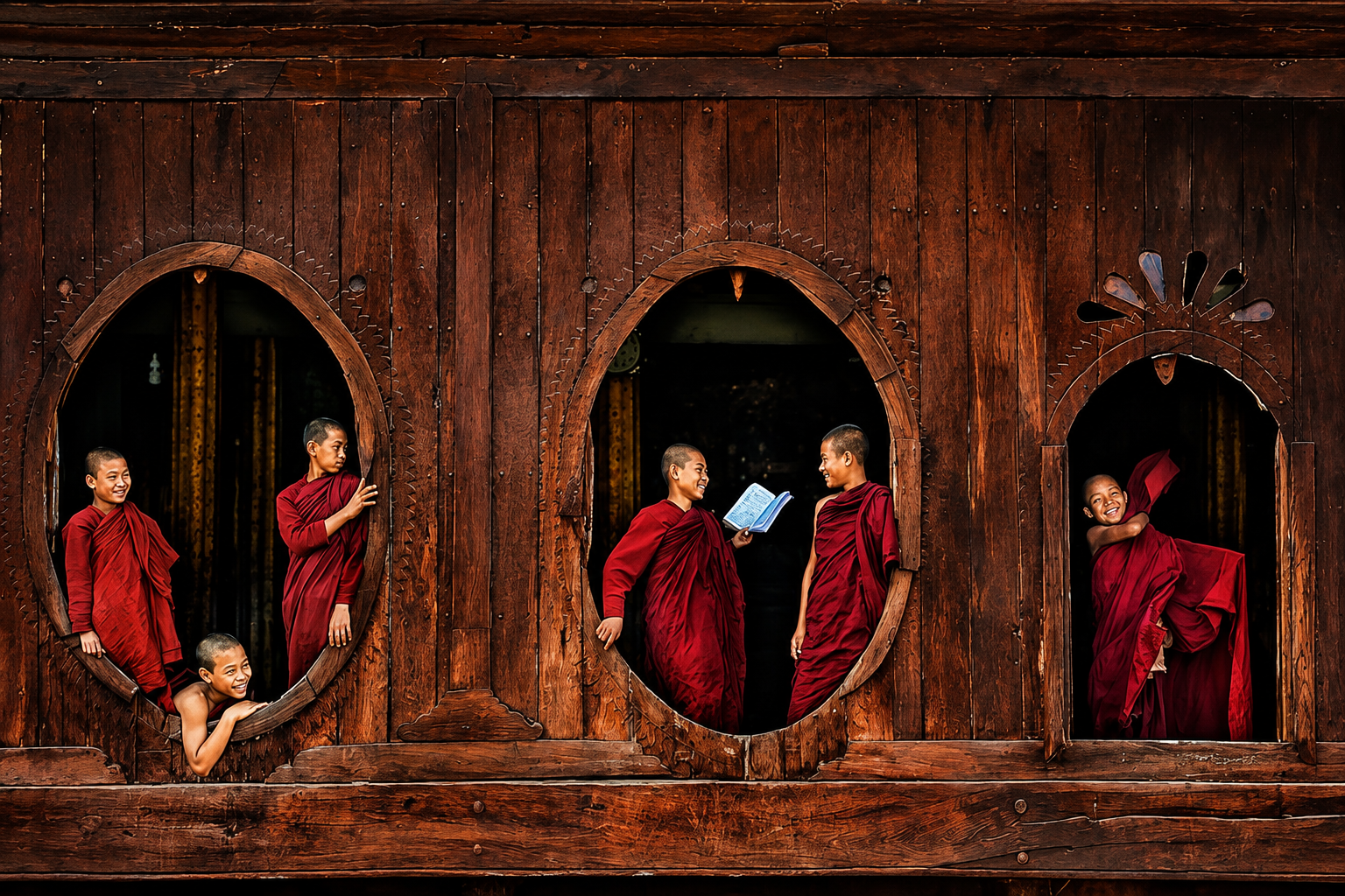 Young monks smiling through carved wooden monastery windows